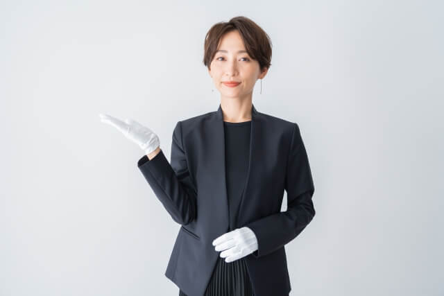 丁寧な仕草のビジネススーツ女性